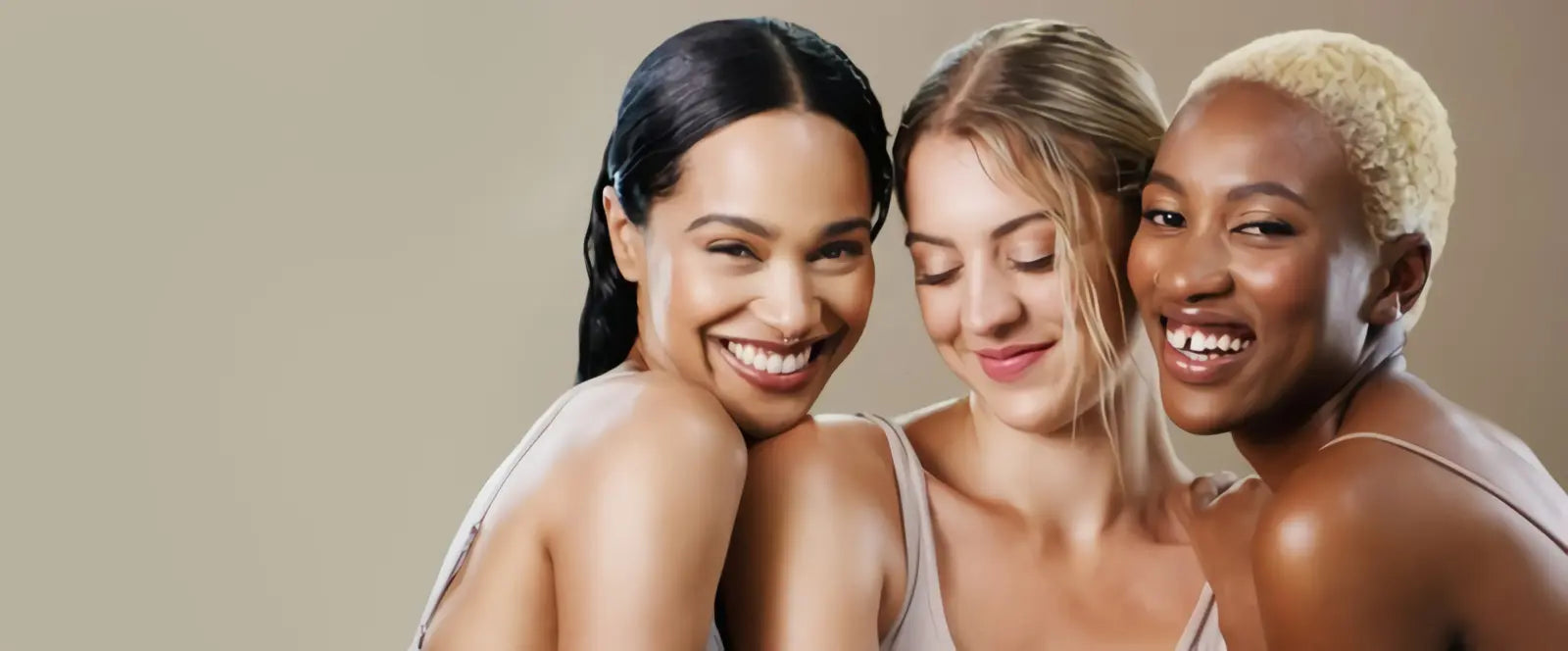 Three women smiling and showcasing natural beauty with flawless makeup from the Baliveno cosmetics beauty collection.