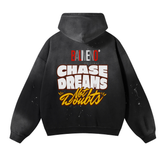The ODMPOD Baliveno Vintage Wash Frayed Fleece Hoodie (360 GSM) is black with paint splatter, featuring BALVENO ORIGINAL and CHASE DREAMS Not Doubts in bold white and yellow letters on the back.