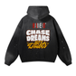 The ODMPOD Baliveno Vintage Wash Frayed Fleece Hoodie (360 GSM) is black with paint splatter, featuring BALVENO ORIGINAL and CHASE DREAMS Not Doubts in bold white and yellow letters on the back.